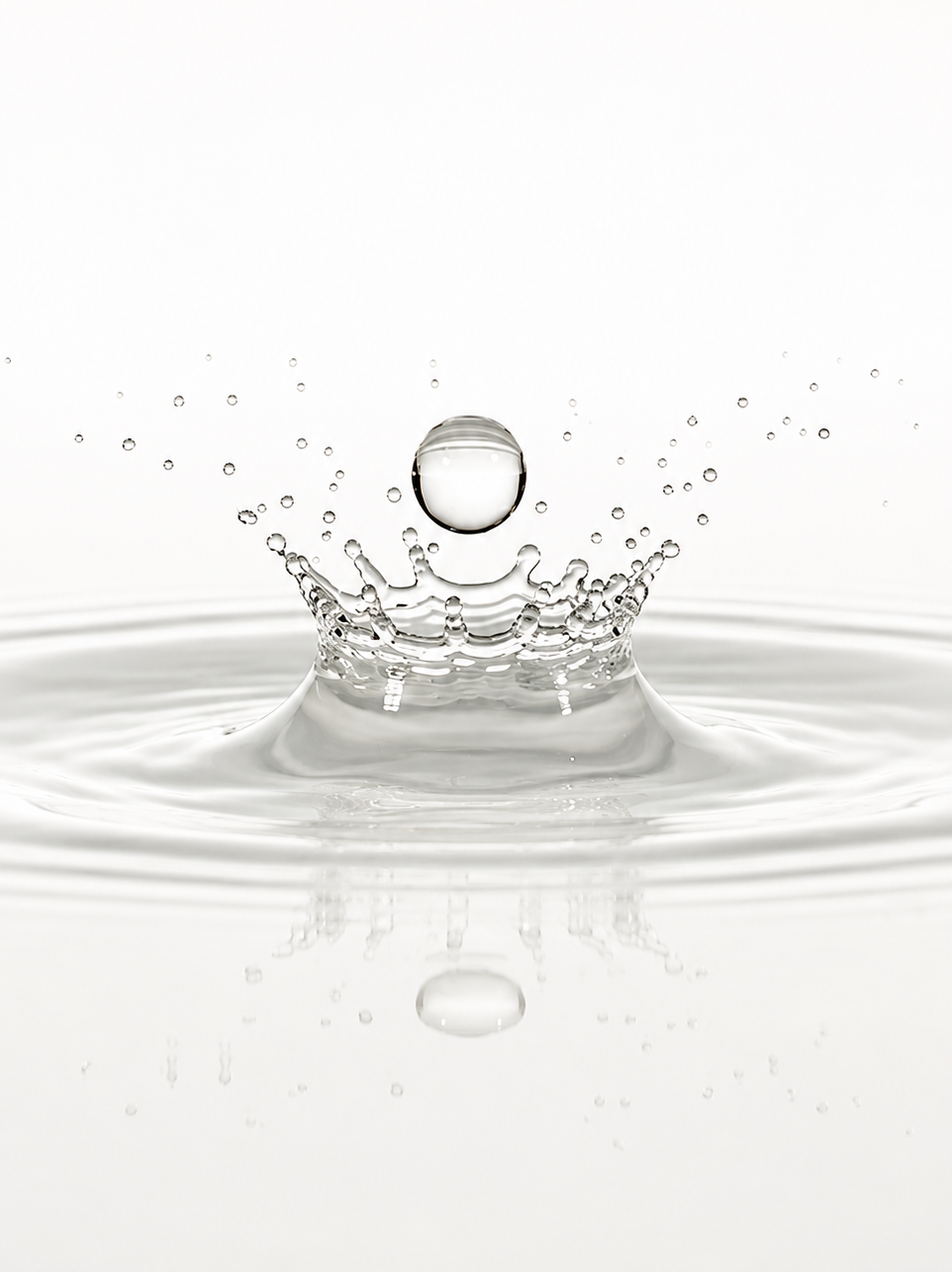 Water droplet creating a circular splash on a white background
