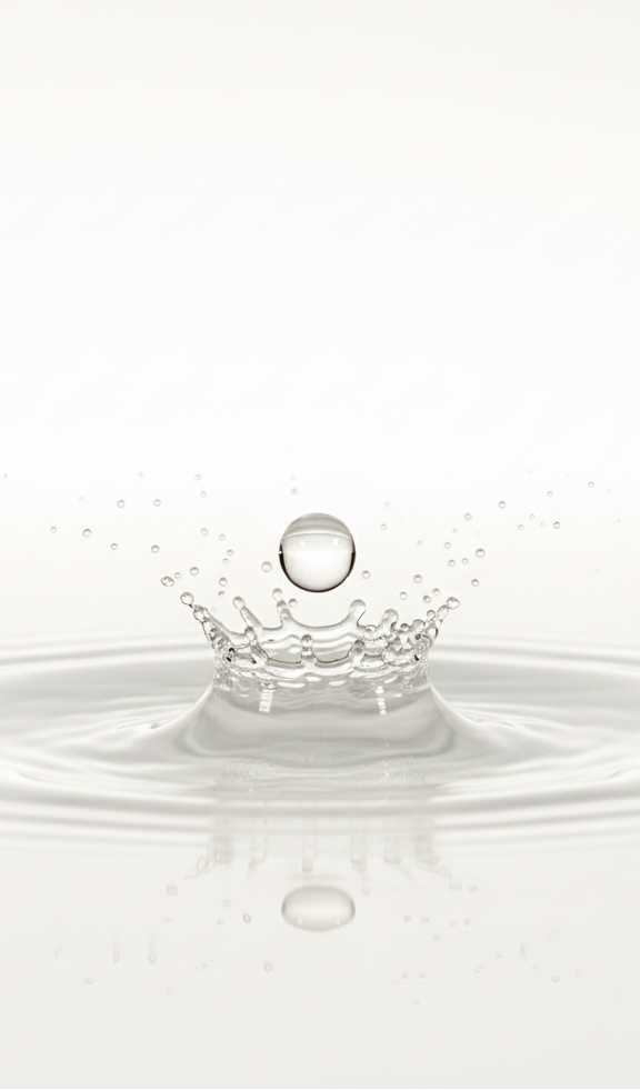 Water droplet creating ripples on a white background